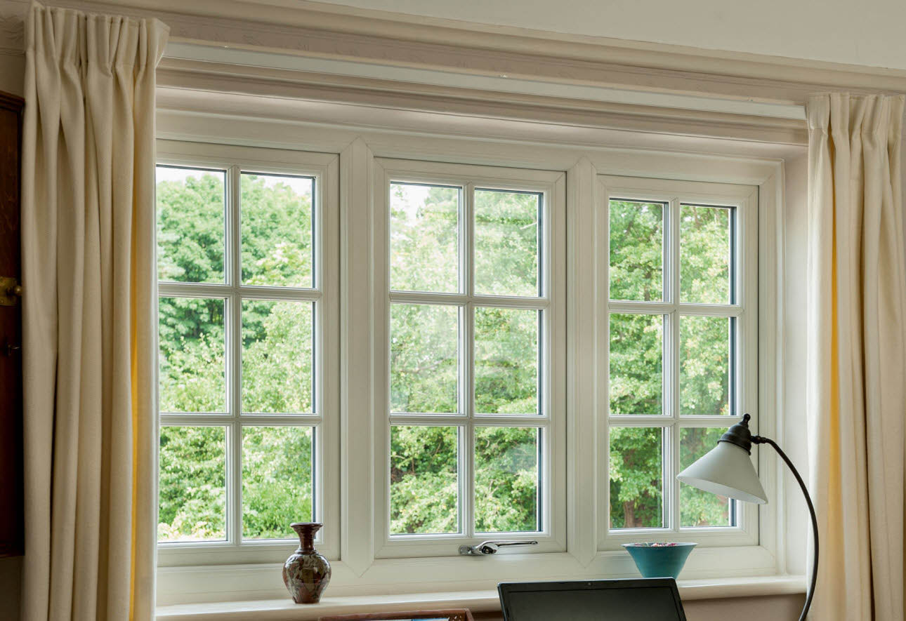 Interior view of Rehau uPVC casement windows in a Gloucestershire home, highlighting their traditional style and energy efficiency. This image relates to the page by showcasing the benefits of replacing windows with modern, practical uPVC designs.